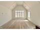 Bedroom with vaulted ceilings, hardwood floors and large window at 5504 Kingwood Dr, Raleigh, NC 27609