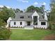 Elegant home showcasing a manicured lawn, classic white siding, and a welcoming entrance at 5504 Kingwood Dr, Raleigh, NC 27609