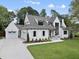 Beautiful home with a three-car garage, manicured lawn, and a welcoming front entrance at 5504 Kingwood Dr, Raleigh, NC 27609