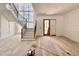 View of the bright foyer with staircase, hardwood floors, statement windows and elegant trim work at 5504 Kingwood Dr, Raleigh, NC 27609
