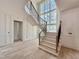 Bright foyer showcases a curved staircase, high ceilings, and decorative wall paneling at 5504 Kingwood Dr, Raleigh, NC 27609