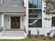 Close-up of the front entrance showcasing a stone staircase, wooden door, and elegant design at 5504 Kingwood Dr, Raleigh, NC 27609