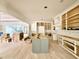 Open concept kitchen area with unfinished cabinets, light hardwood floors, and modern island at 5504 Kingwood Dr, Raleigh, NC 27609