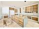 Large kitchen features unfinished cabinets, white crown molding, and modern design elements at 5504 Kingwood Dr, Raleigh, NC 27609