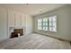 Well-lit room features a fireplace with marble accents and a large window at 5504 Kingwood Dr, Raleigh, NC 27609