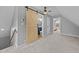 Attic space with barn door access to a bathroom and open bedroom at 555 Canterwood Dr, Mebane, NC 27302