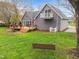 The home has a large manicured backyard, featuring a deck and a swing at 555 Canterwood Dr, Mebane, NC 27302
