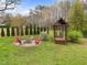 Backyard featuring a firepit with Adirondack chairs and a separate gazebo with swinging chairs at 555 Canterwood Dr, Mebane, NC 27302