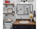 Bathroom featuring wood shelving, shiplap walls, and modern sink at 555 Canterwood Dr, Mebane, NC 27302