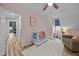 Bright Bedroom featuring a crib and view into the hallway at 555 Canterwood Dr, Mebane, NC 27302