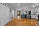Open kitchen featuring white cabinets, stainless steel appliances and wood floors at 555 Canterwood Dr, Mebane, NC 27302