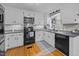 Well-lit kitchen featuring modern appliances, granite countertops and white cabinetry at 555 Canterwood Dr, Mebane, NC 27302