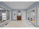 Living room with fireplace, tiled flooring, and large windows allowing ample light at 555 Canterwood Dr, Mebane, NC 27302