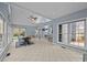 Spacious living room with large windows, ceiling fan, and tile flooring at 555 Canterwood Dr, Mebane, NC 27302