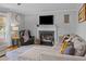 Cozy living room featuring a fireplace, comfortable seating, and natural light at 555 Canterwood Dr, Mebane, NC 27302