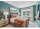 Inviting bedroom with soft lighting, a comfortable bed, and scenic wall art at 605 Callan View Ave, Wake Forest, NC 27587