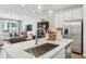 Open kitchen view into the living room with stainless steel appliances and eat in dining area at 605 Callan View Ave, Wake Forest, NC 27587