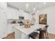 Bright kitchen features white cabinets, stainless steel appliances, and a stylish island with pendant lighting at 605 Callan View Ave, Wake Forest, NC 27587