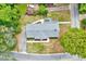 Aerial view of a well-maintained gray home surrounded by green trees and manicured landscaping at 612 E Academy St, Fuquay Varina, NC 27526
