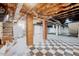 Spacious unfinished basement featuring brick supports, checkered floors and exposed ceiling at 612 E Academy St, Fuquay Varina, NC 27526