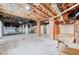Spacious unfinished basement with exposed ceiling, brick supports, and checkered tile floor at 612 E Academy St, Fuquay Varina, NC 27526