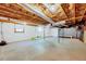 Unfinished basement offers ample space with white walls and visible ceiling beams at 612 E Academy St, Fuquay Varina, NC 27526