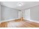 Neutral bedroom featuring hardwood floors, window, and two closets with doors at 612 E Academy St, Fuquay Varina, NC 27526