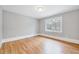 Bright bedroom featuring a beautiful hardwood floor and neutral paint at 612 E Academy St, Fuquay Varina, NC 27526