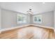 This is a bright dining room featuring hardwood floors, neutral walls, and natural light from the windows at 612 E Academy St, Fuquay Varina, NC 27526