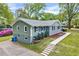 View of the home showing both siding and gray brick, landscaping and the sidewalk leading to the front entrance at 612 E Academy St, Fuquay Varina, NC 27526