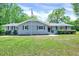 Charming single-story home featuring a well-manicured lawn, a gray brick facade and inviting curb appeal at 612 E Academy St, Fuquay Varina, NC 27526