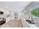 Bright kitchen with stainless appliances, marble countertops, and white cabinets at 612 E Academy St, Fuquay Varina, NC 27526