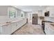 Bright kitchen with stainless steel appliances and marble countertops at 612 E Academy St, Fuquay Varina, NC 27526