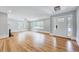 This spacious living room has gleaming hardwood floors, lots of natural light, and a view of the front entry at 612 E Academy St, Fuquay Varina, NC 27526