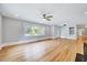 Sun-filled living room showcasing hardwood floors, a ceiling fan, and an abundance of natural light at 612 E Academy St, Fuquay Varina, NC 27526
