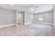 Large bedroom with soft carpet, ceiling fan, neutral walls, and bright natural light at 612 E Academy St, Fuquay Varina, NC 27526