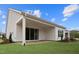 Inviting backyard featuring a covered patio, lush green grass, and well-maintained siding at 616 Gainer Dr # 15, Raleigh, NC 27610