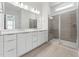 A pristine bathroom with double sinks, ample storage, and a tiled shower with a glass enclosure at 616 Gainer Dr # 15, Raleigh, NC 27610