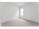 Cozy bedroom showcasing neutral carpet, a large window, and white trim at 616 Gainer Dr # 15, Raleigh, NC 27610