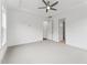 A spacious bedroom boasts neutral carpet, ceiling fan, and access to an adjacent room or closet at 616 Gainer Dr # 15, Raleigh, NC 27610