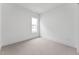 Clean bedroom featuring neutral carpet, a bright window, and neutral walls at 616 Gainer Dr # 15, Raleigh, NC 27610