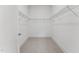 An empty walk-in closet with carpeted floors and wire shelves offers plenty of storage space at 616 Gainer Dr # 15, Raleigh, NC 27610
