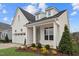 Side view of the home shows well-manicured landscaping and classic white brick exterior at 616 Gainer Dr # 15, Raleigh, NC 27610