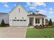 Charming white brick home featuring a two-car garage, well-maintained landscaping, and a welcoming front porch at 616 Gainer Dr # 15, Raleigh, NC 27610