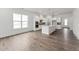 Bright kitchen featuring white cabinets, stainless steel appliances, kitchen island, and hardwood flooring at 616 Gainer Dr # 15, Raleigh, NC 27610