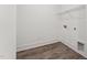 An efficient laundry room features wood-look floors, white walls, and metal shelving for smart organization at 616 Gainer Dr # 15, Raleigh, NC 27610