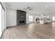 Open-concept living room with modern fireplace, hardwood floors, and a view of the kitchen at 616 Gainer Dr # 15, Raleigh, NC 27610