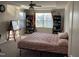 Bedroom with a bed, shelves, window, and natural light, perfect for relaxation or study at 6332 Andante Ave, Raleigh, NC 27616