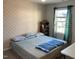 Comfortable bedroom with a patterned bed, window with curtains, and bookshelf, offering a relaxing retreat at 6332 Andante Ave, Raleigh, NC 27616
