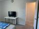 Bedroom featuring a bed, desk, and doorway, creating a simple and functional living space at 6332 Andante Ave, Raleigh, NC 27616